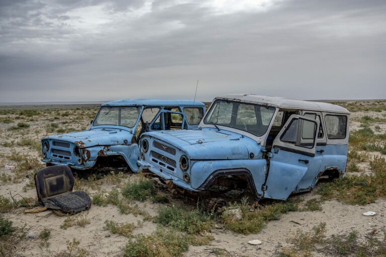 Dilapidated cars sit along the dried-up Aral Sea near Aralsk, Kazakhstan, Saturday, July 1, 2023. (AP Photo/Ebrahim Noroozi)