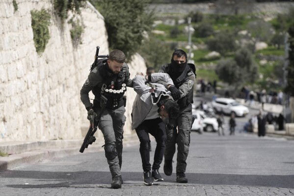 Israeli Border Police detain a Palestinian man ahead of Friday prayers at the Al-Aqsa Mosque compound in the Old City of Jerusalem, Friday, March 1, 2024. (AP Photo/Mahmoud Illean)