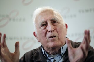 FILE - In this file photo dated Wednesday, March 11, 2015, showing Jean Vanier, the founder of L'ARCHE, an international network of communities where people with and without intellectual disabilities live and work together, in central London.  An internal report revealed Saturday Feb. 22, 2020, that L’Arche founder Jean Vanier, a respected Canadian religious figure, sexually abused at least six women.  (AP Photo/Lefteris Pitarakis, FILE)