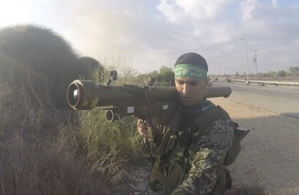 In this image from body camera video during the Oct. 7, 2023, surprise attack on Israel, a Hamas fighter holds a Russian-designed 9M32 Strela anti-aircraft missile. An Associated Press analysis of more than 150 videos and photos taken in the three months of combat since Hamas launched its Oct. 7 surprise attack on Israel shows the militant group has amassed a diverse patchwork arsenal of weapons from around the world – much of it smuggled past a 17-year blockade that was aimed at stopping just such a military buildup. (South First Responders via AP)
