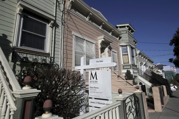 This Feb. 18, 2020, photo shows a real estate sign in front of a home for sale in San Francisco. On Thursday, Feb. 27, Freddie Mac reports on this week’s average U.S. mortgage rates. (AP Photo/Jeff Chiu)