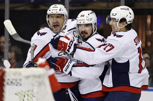 Washington Capitals left wing Marcus Johansson (90) is congratulated on his goal against the New York Rangers by Alex Ovechkin and Dylan Strome (17) during the first period of an NHL hockey game Tuesday, Dec. 27, 2022, in New York. (AP Photo/Adam Hunger)