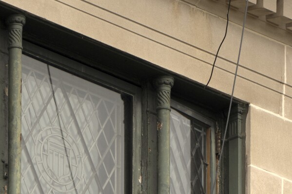 Wires are seen leading from a top floor corner window to the roof of the headquarters of the General Services Administration (GSA) are photographed Wednesday, April 2, 2025, in Washington. (AP Photo/Mark Schiefelbein)