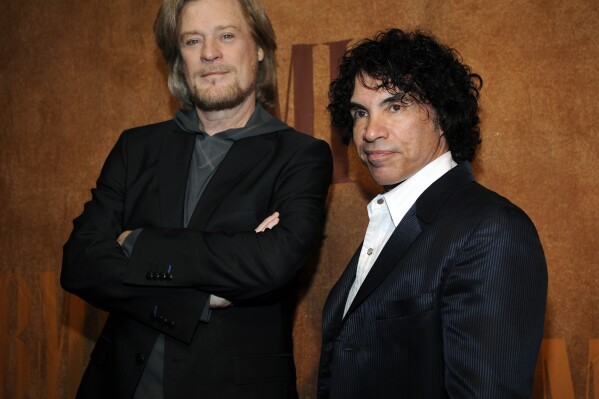 FILE - Daryl Hall, left, and John Oates, recipients of BMI Icons awards, pose together before the 56th annual BMI Pop Awards in Beverly Hills, Calif., on May 20, 2008. Hall has sued his longtime music partner John Oates, arguing that his plan to sell off his share of a joint venture would violate a business agreement the duo had.(AP Photo/Chris Pizzello, File)