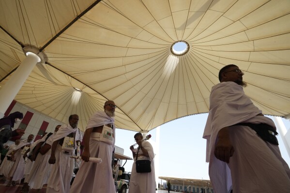 Pilgrims walk at the Hajj terminal of King Abdulaziz International Airport in Jeddah, Saudi Arabia, Tuesday, June 20, 2023. Saudi Arabia has ambitious plans to welcome millions more pilgrims to Islam's holiest sites. But as climate change heats an already scorching region, the annual Hajj pilgrimage could prove even more daunting. (AP Photo/Amr Nabil)
