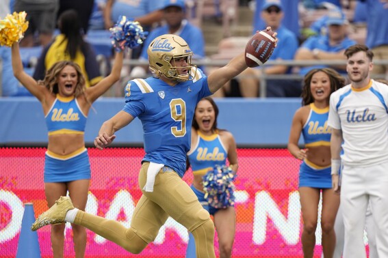 UCLA quarterback Collin Schlee celebrates as he scores a touchdown during the first half of an NCAA college football game against North Carolina Central Saturday, Sept. 16, 2023, in Pasadena, Calif. (AP Photo/Mark J. Terrill)