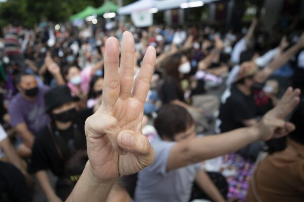 Pro-democracy activists flash three-fingered salutes outside remand prison, in which some of the activists are kept in Bangkok, Thailand, Friday, Oct. 23, 2020. Thailand's government on Thursday canceled a state of emergency it had declared last week for Bangkok in a gesture offered by the embattled prime minister to cool student-led protests seeking democracy reforms. (AP Photo/Sakchai Lalit)