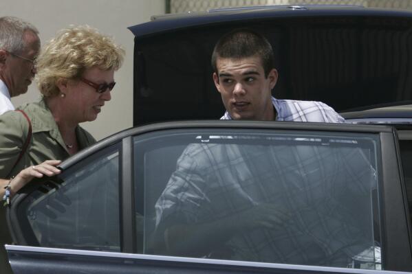 FILE - Dutch teen Joran van der Sloot, 18, enters his family's car as his mother Anita closes the door after he was conditionally released from the KAI jail in San Nicolas, Aruba, Sept. 3, 2005. Van der Sloot, the prime suspect in the 2005 disappearance of American student Natalee Holloway on a Dutch Caribbean island, is facing extradition from Peru in 2023 to face criminal charges in the United States, while he has never been charged in connection with her disappearance. (AP Photo/Leslie Mazoch, File)