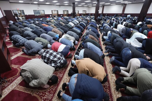 Men pray at the Islamic Center of Detroit in Detroit, Jan. 26, 2024. Facing a room of Arab American activists from across the country angry at President Joe Biden's response to the Israel-Gaza war, a well-known adviser to Donald Trump was asked this week what the former president would have done differently had he been in office. (AP Photo/Paul Sancya, File)