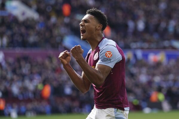 Aston Villa's Ollie Watkins celebrates after team-mate Moussa Diaby scores their second goal of the game during the English Premier League soccer match between Bournemouth and Aston Villa at Villa Park stadium in Birmingham, England, Sunday April 21, 2024. (David Davies/PA via AP)