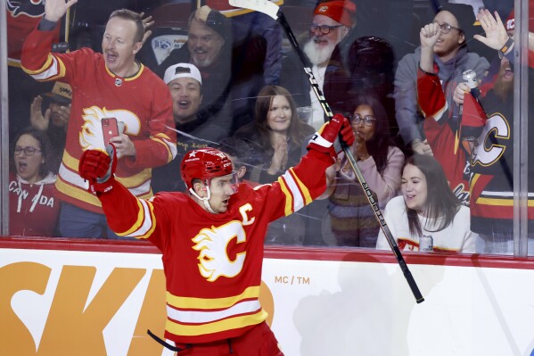 Calgary Flames center Mikael Backlund celebrates his short-handed game-winning goal against the Florida Panthers during the third period of an NHL hockey game in Calgary, Alberta, Monday, Dec. 18, 2023. (Larry MacDougal/The Canadian Press via AP)