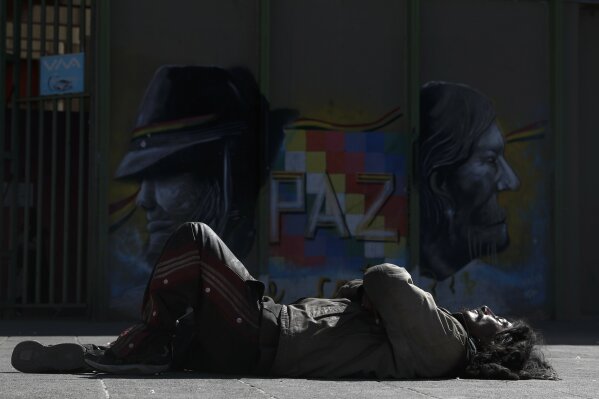 A homeless man sleeps at San Francisco square amid a government ordered lockdown to contain the spread of the new coronavirus, in La Paz, Bolivia, Thursday, June 25, 2020. (AP Photo/Juan Karita)