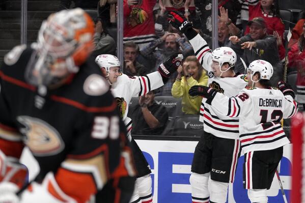 Chicago Blackhawks center Kirby Dach, right, celebrates his tying