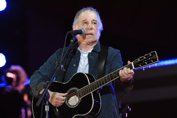FILE - Paul Simon performs at Global Citizen Live in Central Park in New York on Sept. 25, 2021. Simon's latest honor places him among public figures well outside the music industry. He is this year's winner of PEN America's PEN/Audible Literary Service Award, Thursday, March 7, 2024, which previously has been given to former President Barack Obama, the late Nobel laureate Toni Morrison and Stephen King among others.(Photo by Evan Agostini/Invision/AP, File)