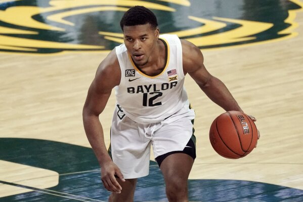 FILE - Baylor's Jared Butler (12) brings the ball up the court against Auburn during the second half of an NCAA college basketball game in Waco, Texas, in this Saturday, Jan. 30, 2021, file photo. Butler has made The Associated Press All-America first team, announced Tuesday, March 16, 2021.(AP Photo/Chuck Burton, File)