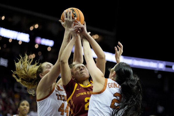 Iowa State guard Arianna Jackson, center, battles for a rebound with Texas forward Taylor Jones (44) and guard Shaylee Gonzales (2) during the first half of an NCAA college basketball game for the Big 12 tournament championship Tuesday, March 12, 2024, in Kansas City, Mo. (AP Photo/Charlie Riedel)