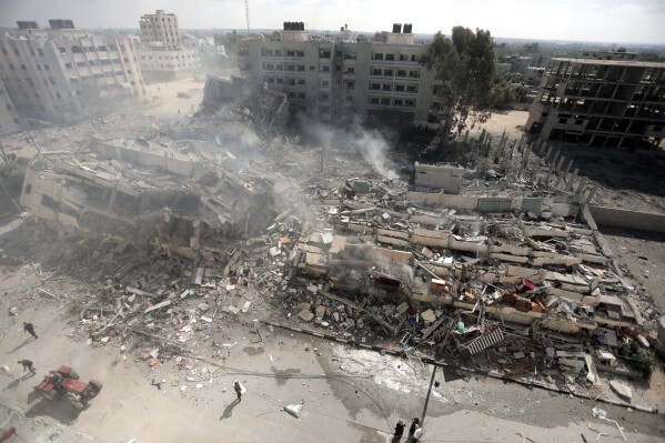 Smoke rises from destroyed buildings, following Israeli airstrikes on Gaza City, central Gaza Strip, Thursday, Oct. 19, 2023. (AP Photo/Mohammed Dahman)
