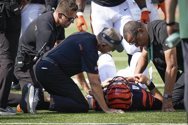 Cincinnati Bengals quarterback Joe Burrow is tended to by the medical staff after being injured on a play in the first half of an NFL football game against the Green in Cincinnati, Sunday, Oct. 10, 2021. (AP Photo/Bryan Woolston)