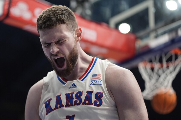 FILE - Kansas center Hunter Dickinson (1) celebrates after dunking the ball during the first half of an NCAA college basketball game against BYU, Tuesday, Feb. 27, 2024, in Lawrence, Kan. (AP Photo/Charlie Riedel, File)