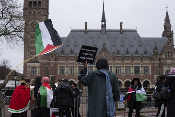 Pro-Palestinians demonstrators wave flags as they protest outside the United Nations' highest court during historic hearings, in The Hague, Netherlands, Monday, Feb. 19, 2024. The Palestinian foreign minister has accused Israel of apartheid and urged the United Nations鈥� top court to declare that Israel鈥檚 occupation of lands sought for a Palestinian state is illegal. If the situation endures, the Palestinians say that any hope for a two-state future will die. The allegation came at the start of historic hearings into the legality of Israel鈥檚 57-year occupation of lands sought for a Palestinian state. (AP Photo/Peter Dejong)