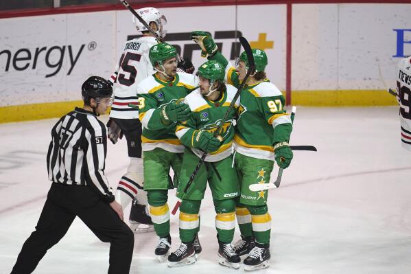 Minnesota Wild right wing Mats Zuccarello (36) celebrates with center Sam Steel (13) and left wing Kirill Kaprizov (97) after scoring during the first period of an NHL hockey game against the Chicago Blackhawks Friday, Dec. 16, 2022, in St. Paul, Minn. (AP Photo/Abbie Parr)