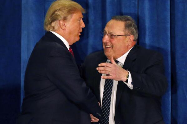 FILE - Republican presidential candidate Donald Trump is welcomed to the stage by Maine Gov. Paul LePage at campaign stop in Portland, Maine, in this March 3, 2016 file photo. LePage, who moved to Florida after his second term, has returned to Maine to challenge Democratic Gov. Janet Mills. (AP Photo/Robert F. Bukaty)