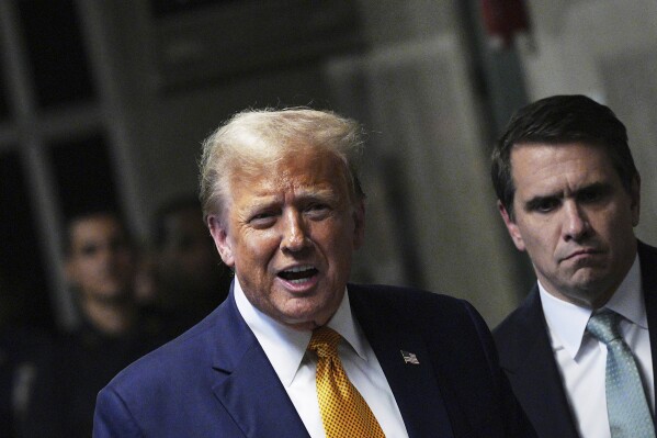 Former President Donald Trump talks to the press with his attorney, Todd Blanche, right, outside the courtroom of his trial in Manhattan criminal court Tuesday, May 14, 2024, in New York. (Curtis Means/Pool Photo via AP)