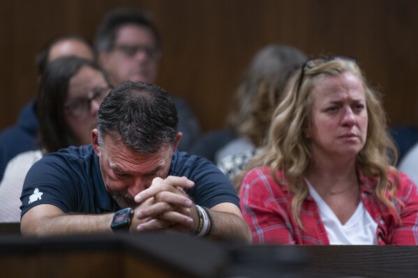 Buck Myre, left, and Sheri Myre parents of slain son Tate Myre, listen to testimony as their son's killer, Ethan Crumbley appears in the Oakland County courtroom of Kwame Rowe, on Aug. 18, 2023, in Pontiac, Mich. The teenager who killed four students at Michigan’s Oxford High School will learn whether he will spend his life in prison or get a chance for parole in the decades ahead. Judge Kwame Rowe will announce his decision Friday, Sept. 29. (Mandi Wright/Detroit Free Press via AP, Pool)