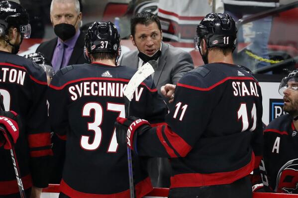 FILE - In this June 1, 2021, file photo, Carolina Hurricanes head coach Rod Brind 'Amour, center, speaks with players during the third period in Game 2 of an NHL hockey Stanley Cup second-round playoff series against the Tampa Bay Lightning in Raleigh, N.C. The Hurricanes have been to the playoffs for three straight years and are hoping offseason changes help them make an even deeper run this season. (AP Photo/Karl B DeBlaker, File)