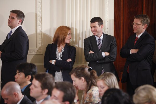 FILE - In this June 29, 2011 file photo, from left,  White House Communications Director Dan Pfeiffer; Deputy Communications Director Jen Psaki; Senior Adviser David Plouffe; and Press Secretary Jay Carney stand in the East Room as President Barack Obama holds a news conference at the White House in Washington. (AP Photo/Charles Dharapak, File)