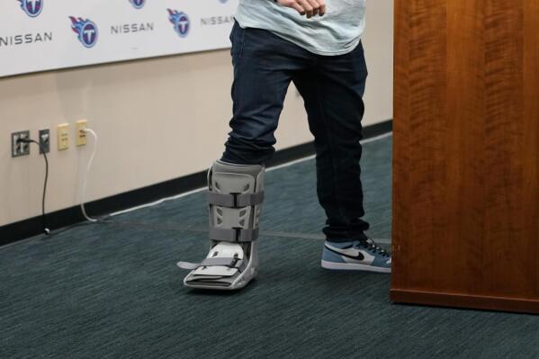 Tennessee Titans quarterback Ryan Tannehill wears a boot on his foot during a news conference following an NFL football game between the Tennessee Titans and the Indianapolis Colts Sunday, Oct. 23, 2022, in Nashville, Tenn. The Titans won 19-10. (AP Photo/Mark Humphrey)