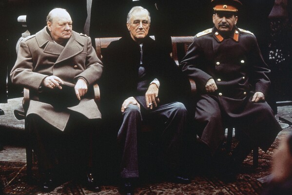 FILE - This is a Feb. 4, 1945, file photo of from left, British Prime Minister Winston Churchill, U.S. President Franklin Roosevelt and Soviet Premier Josef Stalin as they sit on the patio of Livadia Palace, Yalta, Crimea.  Initially hailed as a major success, the conference later came to be viewed by some as the moment that the U.S. ceded too much influence to the Soviets and the trigger for the Cold War.  (AP Photo/File)