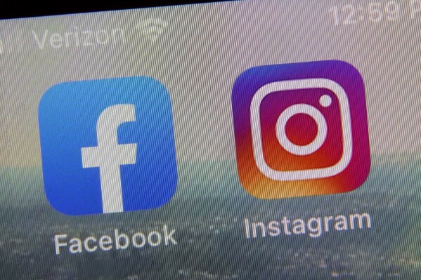 FILE - This photo shows the mobile phone app logos for, from left, Facebook and Instagram in New York, Oct. 5, 2021. British lawmakers have on Wednesday, Sept. 20, 2023 approved an ambitious but controversial new internet safety law with wide-ranging powers to crack down on digital and social media companies like TikTok, Google and Facebook and Instagram parent Meta. (AP Photo/Richard Drew, file)
