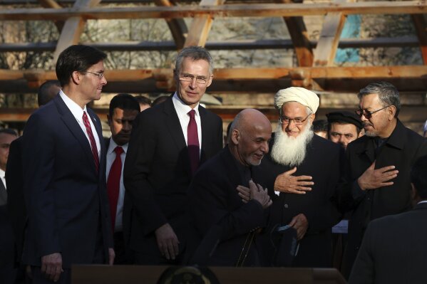 FILE- In this Feb. 29, 2020 file photo, Afghan President Ashraf Ghani, center, arrives with NATO Secretary General Jens Stoltenberg, second left, and then U.S. Secretary of Defense Mark Esper, left, for a joint news conference after the US signed a peace agreement with Taliban militants which includes a May 1, 2021, deadline for a final U.S. troop withdrawal, at the presidential palace in Kabul, Afghanistan. The Biden administration’s surprise announcement of an unconditional troop withdrawal from Afghanistan by Sept. 11, 2021, appears to strip the Taliban and the Afghan government of considerable leverage, pressuring them to reach a peace deal. (AP Photo/Rahmat Gul, File)