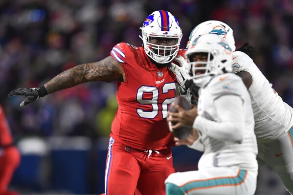 FILE - Buffalo Bills defensive tackle DaQuan Jones (92) pressures Miami Dolphins quarterback Tua Tagovailoa (1) during the second half of an NFL football game in Orchard Park, N.Y., Saturday, Dec. 17, 2022. The Buffalo Bills opened a three-week window on Tuesday, Dec. 19, 2023, for starting defensive tackle DaQuan Jones to be activated from injured reserve after missing nine games with a torn pectoral muscle. While the chances of Jones’ being activated are promising, coach Sean McDermott said it was unlikely that will happen in time for Saturday, when Buffalo (8-4) travels to play the Los Angeles Chargers (5-9). (AP Photo/Adrian Kraus, File)