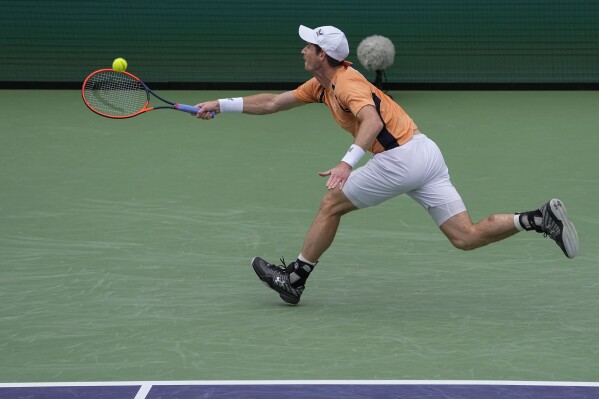Andy Murray, of Britain, hits a return to David Goffin, of Belgium, during their match at the BNP Paribas Open tennis tournament Wednesday, March 6, 2024, in Indian Wells, Calif. (AP Photo/Mark J. Terrill)
