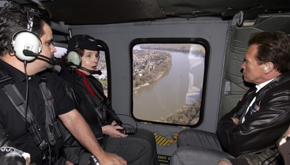 FILE - U.S. Sen. Dianne Feinstein, D-Calif., second from left, talks with Gov. Arnold Schwarznegger, right, and Rep. Richard Pombo, R-Calif., left, while getting an aerial tour of the levees along the Sacramento River in a California National Guard Helicopter, near Sacramento, Calif., Wednesday, Feb. 22, 2006. Feinstein and Pombo joined with Schwarzenegger, who has announced that he will spend $2.5 billion over the next 10 years to strengthen levees and improve the flood management system, in calling on the federal government to provide federal funds to help cover the costs. (AP Photo/Rich Pedroncelli, Pool, File)