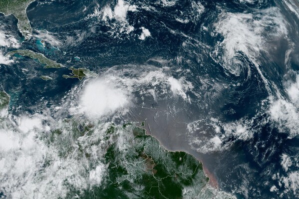 In this Monday, Aug. 21, 2023, 9:03am ET satellite image provided by the National Oceanic and Atmospheric Administration, Tropical Storm Franklin moves south of Hispaniola island. Earlier Monday, there were three tropical storms swirling through the Caribbean and Atlantic Ocean. One of those storms, Emily, dissipated late Monday morning, and another storm, Gert, was expected to do the same. (NOAA via AP)