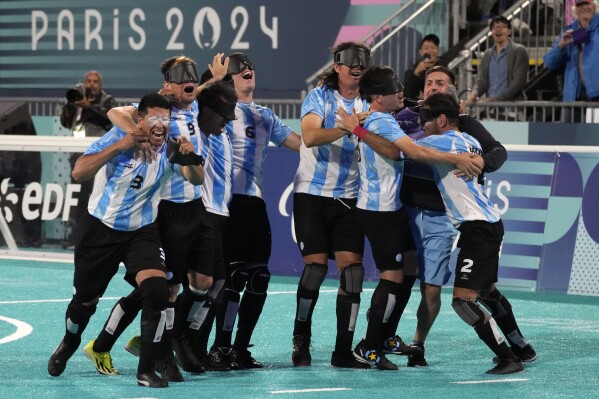 Argentina players celebrate after winning the semifinal blind football match between Argentina and Brazil at the 2024 Paralympics, Thursday, Sept. 5, 2024, in Paris, France. (AP Photo/Michel Euler)