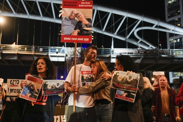 Families and friends of about 240 hostages held by Hamas in Gaza call for Israeli Prime Minister Benjamin Netanyahu to bring them home during a demonstration in Tel Aviv, Israel Tuesday, Nov. 21, 2023. Israel's Cabinet was convening Tuesday to consider a possible deal for the release of some of the hostages held by Hamas in exchange for a temporary halt to Israel's military offensive in Gaza. Hamas captured the hostages in an Oct. 7 cross-border attack that killed at least 1,200 people and triggered an Israeli invasion of Gaza. (AP Photo/Ariel Schalit)