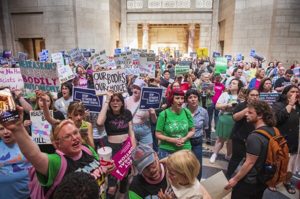 FILE - Protesters chant, "One vote to save our lives," as they are heard in the legislative chamber during a final reading on a bill that combined a 12-week abortion ban with a measure to restrict gender-affirming care for people under 19, May 16, 2023, at state Capitol in Lincoln, Neb. Members of the Nebraska Supreme Court appeared on Tuesday, March 5, 2024, to meet with skepticism a state lawyer's defense of a new law that combines a 12-week abortion ban with another measure to limit gender-affirming health care for minors. (Kenneth Ferriera/Lincoln Journal Star via AP, File)