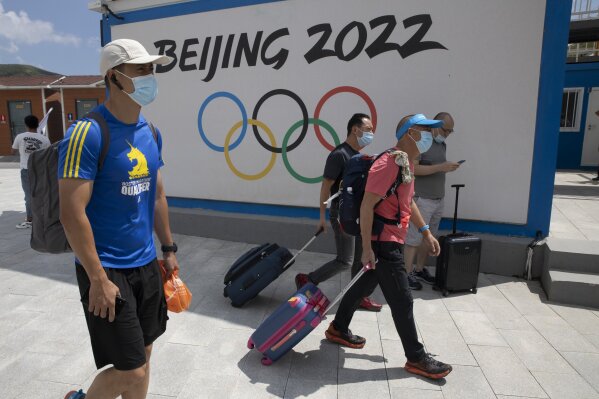 Visitors to Chongli, one of the venues for the Beijing 2022 Winter Olympics, past by the Olympics logo in Chongli in northern China's Hebei Province on Thursday, Aug. 13, 2020. China’s repression in Tibet, the status of the exiled Dalai Lama, and its treatment of ethnic minorities spurred violent protests ahead of Beijing’s 2008 Olympics. It could happen again. China is host to the 2022 Winter Olympics with rumblings of a boycott and calls to remove the games from Beijing because of widespread human rights violations. (AP Photo/Ng Han Guan)