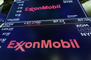 FILE - The logo for ExxonMobil appears above a trading post on the floor of the New York Stock Exchange, Oct. 8, 2019. Massachusetts' highest court on Tuesday, May 24, 2022, rejected a bid by ExxonMobil to dismiss a lawsuit brought by the state that accuses the oil giant of misleading the public about the role its products play in causing climate change. (AP Photo/Richard Drew, File)