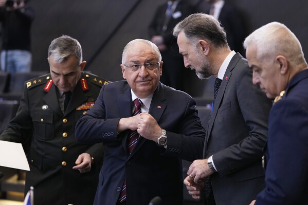 FILE- Turkey's Defense Minister Yasar Guler, second left, speaks with members of his delegation during a meeting of the North Atlantic Council in defense ministers session at NATO headquarters in Brussels, Thursday, Feb. 15, 2024. Turkey's defense minister says plans by U.S.-backed Kurdish groups to hold local elections in northern Syria are “unacceptable" and a threat to Turkey's national security. (AP Photo/Virginia Mayo, File)