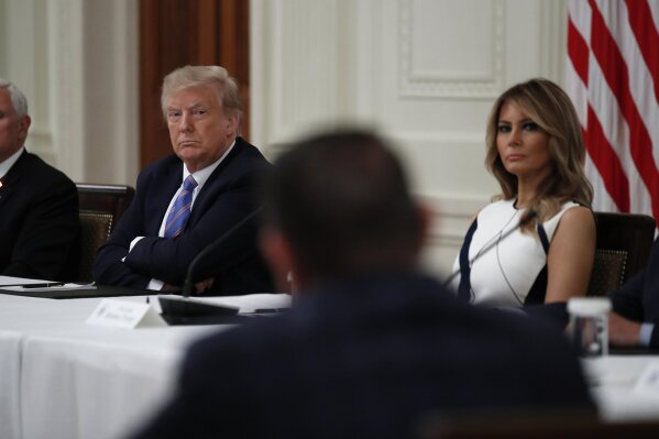 President Donald Trump and first lady Melania Trump listen during a "National Dialogue on Safely Reopening America's Schools," event in the East Room of the White House, Tuesday, July 7, 2020, in Washington. (AP Photo/Alex Brandon)