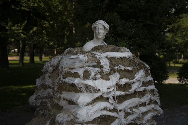 FILE - Weathered sandbags are stacked around the Monument to Dante Alighieri to protect the statue from possible bombing by Russia in Kyiv, Ukraine, Thursday, July 6, 2023. (AP Photo/Jae C. Hong, File)