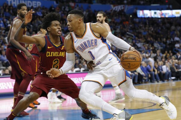 
              Oklahoma City Thunder guard Russell Westbrook (0) drives to the basket around Cleveland Cavaliers guard Collin Sexton (2) during the second half of an NBA basketball game in Oklahoma City, Wednesday, Nov. 28, 2018. Oklahoma City won 100-83. (AP Photo/Alonzo Adams)
            