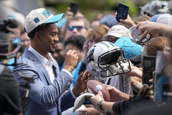 Carolina Panthers number one draft pick quarterback Bryce Young signs autographs after arriving at their NFL football stadium on Friday, April 28, 2023, in Charlotte, N.C. (AP Photo/Chris Carlson)