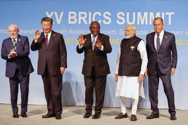 From left, Brazil President Luiz Inacio Lula da Silva, China President Xi Jinping, South African President Cyril Ramaphosa, Prime Minister of India Narendra Modi and Russia's Foreign Minister Sergei Lavrov pose for a BRICS family photo during the 2023 BRICS Summit at the Sandton Convention Centre in Johannesburg, South Africa, Wednesday, Aug. 23, 2023. (Gianluigi Guercia/Pool via AP)
