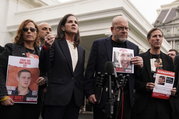 Liz Naftali, great aunt of Abigail More Edan, who was kidnapped but returned in the recent hostage release in Israel, third from left, speaks to reporters after a meeting with President Joe Biden and the families of Americans who were taken hostage by Hamas during the October 7 attacks in Israel, Wednesday, Dec. 13, 2023, in Washington. (AP Photo/Evan Vucci)